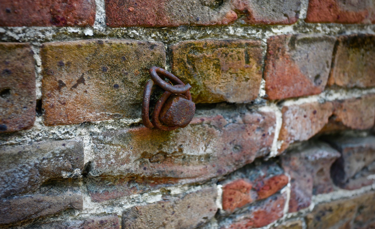 At the barracoons, a nail and remnants of chains remain embedded in brick and mortar.